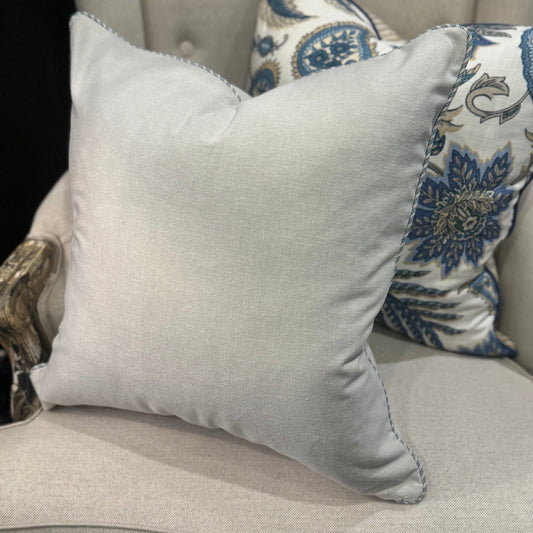 Transform your living space with our Stone Cotton Canvas Cushion, meticulously designed using premium materials. Its understated sophistication creates the perfect backdrop for more vibrant, patterned pieces in your collection. The distinctive blue ticking stripe piping adds a refined touch, while the luxurious feather filling ensures unparalleled softness and comfort for everyday lounging or decorative display.