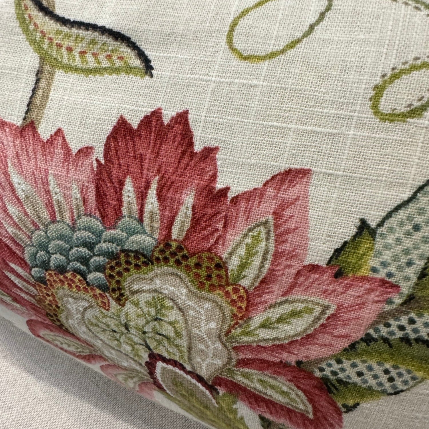 Transform your home decor this season with the elegant Colette Pink &amp; Green Floral Lumbar Cushion. Revel in the stunning pink and green flowers against a neutral backdrop, making it an ideal statement piece for any space. With a plush insert filled with feathers, you can enjoy both luxury and flair. The other side highlights a neutral tone, adding versatility.