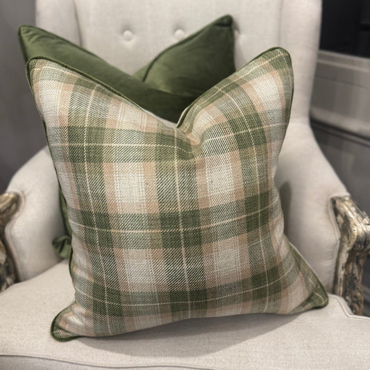 The Green &amp; Ivory Check Cushion combines a high-quality cotton and linen blend with a stylish check design and a neutral reverse crafted from Warwick Fabrics Haven fabric. Accented with green velvet piping, this cushion adds a polished, designer look to your sofa, chair, or bedroom. Its plush feather filling ensures both comfort and elegance in your living space.