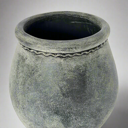 Textured gray pot on a light gray background