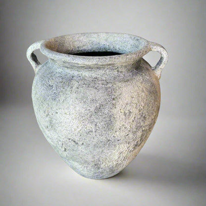 Vintage-style ceramic vase with textured surface on a gray background
