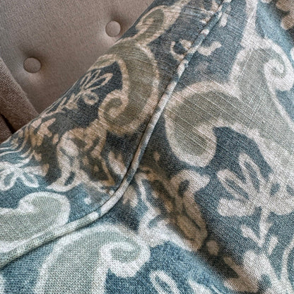 Close-up of a fabric with a floral pattern on a textured surface