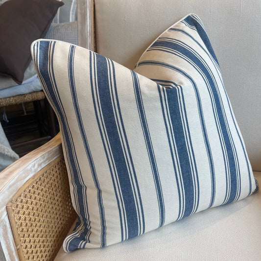 This classic heavyweight Coastal Blue Stripe Cushion, with a sophisticated pattern provided by international fabric house Laura & Kiran, makes any space feel elegant. Combining off white and blue tones, the cushion is complete with a luxuriously soft feather insert to create a truly cozy experience!