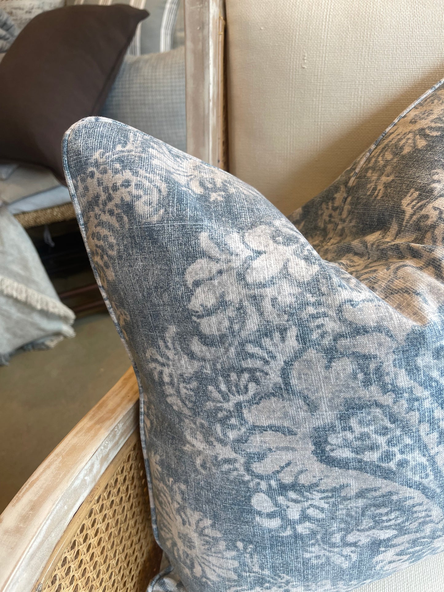 This exquisite Magnolia Art Deco Denim Linen Cushion, flaunting a dainty floral design, infuses a hint of luxury into any space. Uniting tender cream and blue denim shades, the cushion is finished with a luxurious feather insert to ensure ultimate comfort! Corner close up.