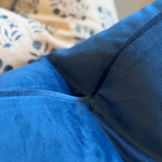 close up of blue velvet cushion