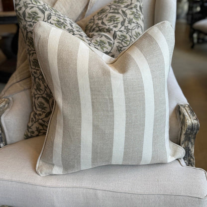 Decorative pillows on a chair with a neutral color scheme