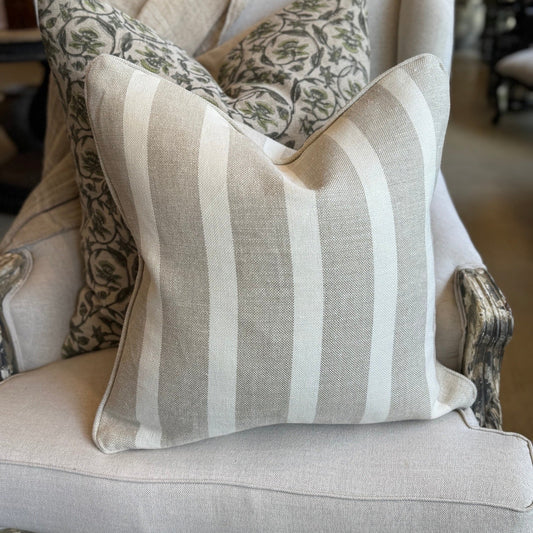 Decorative pillows on a chair with a neutral color scheme