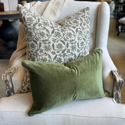 Decorative pillows on a white armchair in a home setting