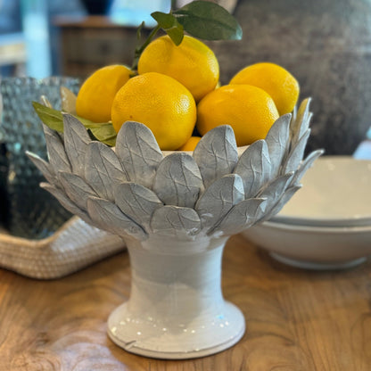 The vibrant Faux Lemon is the perfect option for crafting captivating decorations. Its striking burst of yellow adds a distinctive touch and texture, making it ideal for featuring alone in a bowl or as part of a larger display. Styled.