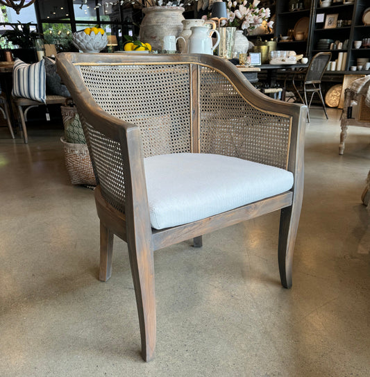 Indulge in the ultimate combination of comfort and style with this classic rattan chair. Skillfully crafted from teak and hand-finished with a serene grey wash, it offers a delightfully tactile and welcoming vibe. Add an extra touch of coziness with a plush cushion or cozy throw. Comes with a soft cream cushion expertly woven from luxurious cotton. Front