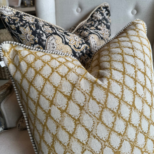 Elevate your home decor with the Cypress Block Printed Linen Ochre Cushion from CHAMOIS, a beloved Swedish brand known for their impeccable style. Crafted from premium Belgian 100% linen and featuring a soft feather insert, this cushion is a must-have for those who appreciate luxurious and high-quality design. Close up detail.