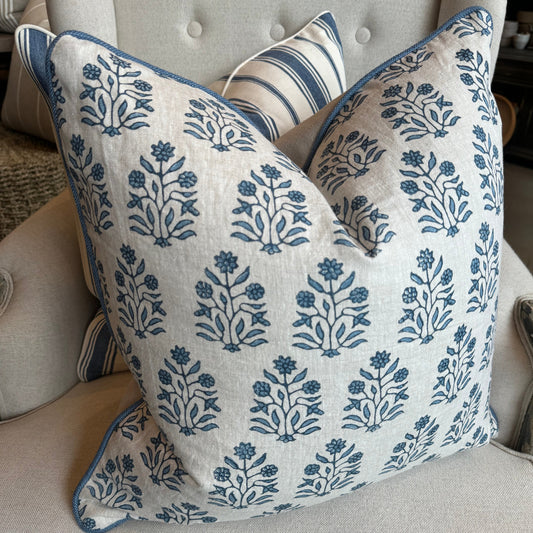 Indulge in the impeccable artistry of this high-quality Amer Azur Oatmeal Navy Floral Linen Cushion. Created by luxury textile house Walter G. and fashioned with dense, 100% linen material, it boasts a stunning navy and light blue floral pattern against an oatmeal backdrop. Complete with a feather insert for ultimate comfort. Reverse lined with oatmeal linen.