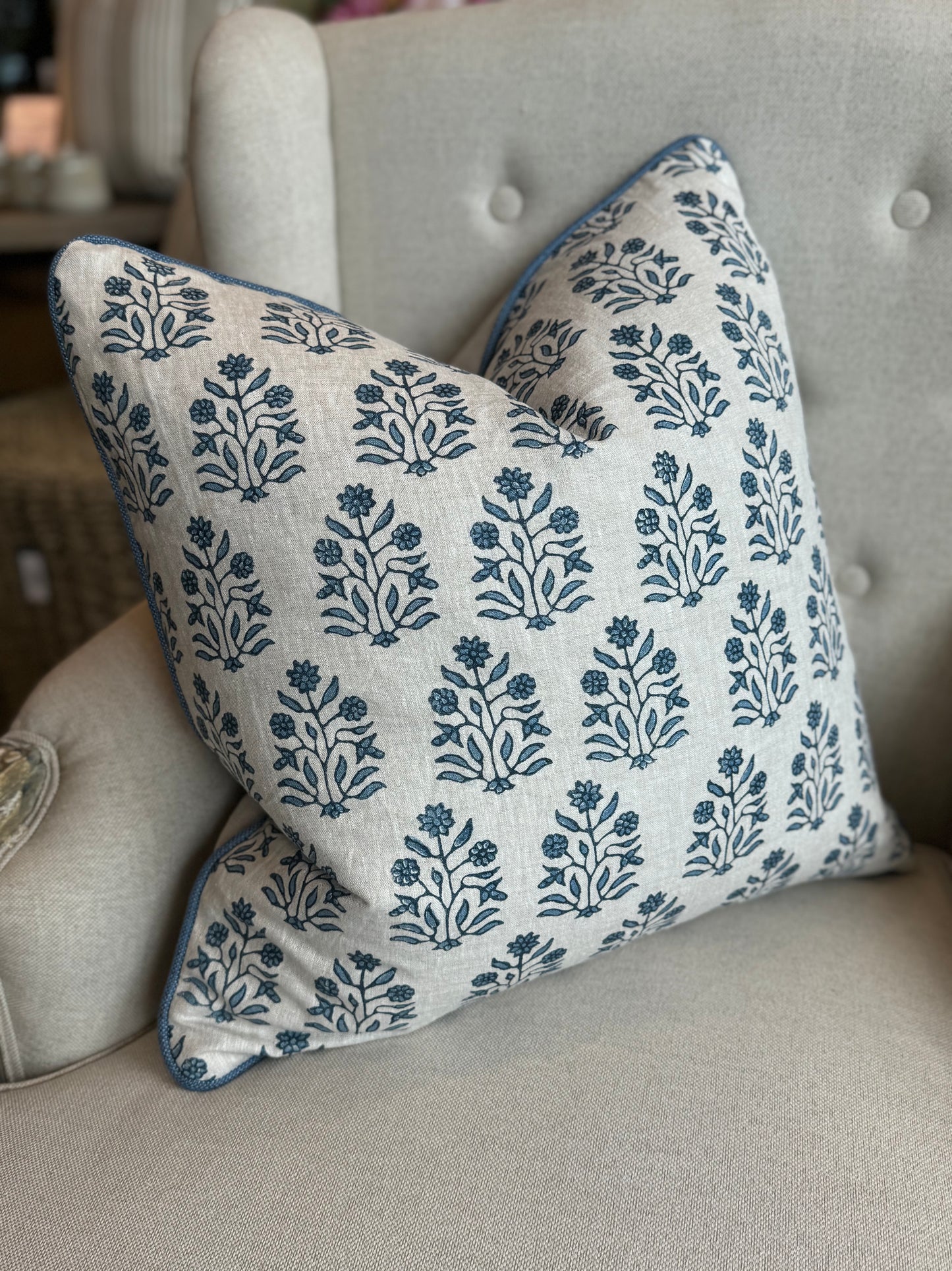 Indulge in the impeccable artistry of this high-quality Amer Azur Oatmeal Navy Floral Linen Cushion. Created by luxury textile house Walter G. and fashioned with dense, 100% linen material, it boasts a stunning navy and light blue floral pattern against an oatmeal backdrop. Complete with a feather insert for ultimate comfort. Reverse lined with oatmeal linen. Side.