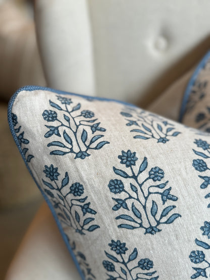 Indulge in the impeccable artistry of this high-quality Amer Azur Oatmeal Navy Floral Linen Cushion. Created by luxury textile house Walter G. and fashioned with dense, 100% linen material, it boasts a stunning navy and light blue floral pattern against an oatmeal backdrop. Complete with a feather insert for ultimate comfort. Reverse lined with oatmeal linen. Corner close up.