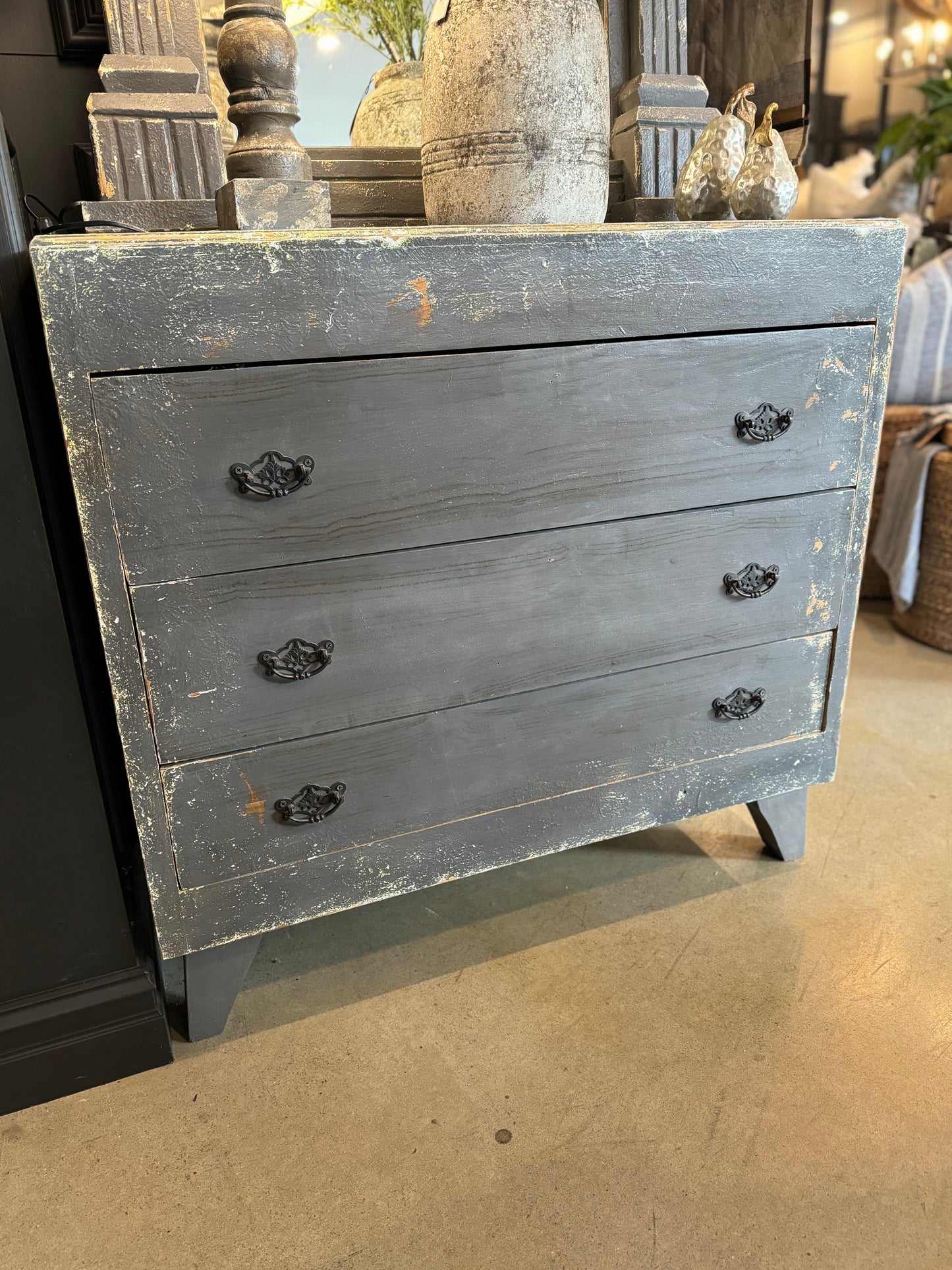 Experience French elegance with the Andika Blue-Grey Distressed Drawers. This timeless reproduction piece adds a touch of luxury to any space, making it a perfect fit for a variety of styles.