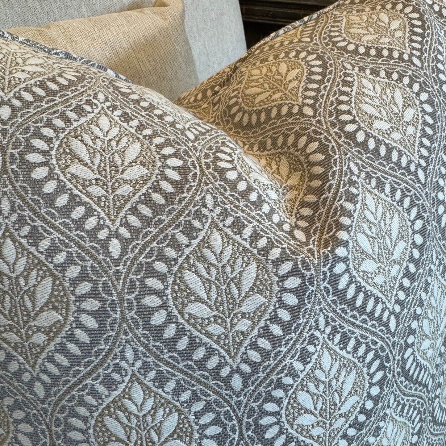 Patterned cushions on a sofa with a neutral background