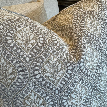 Patterned cushions on a sofa with a neutral background
