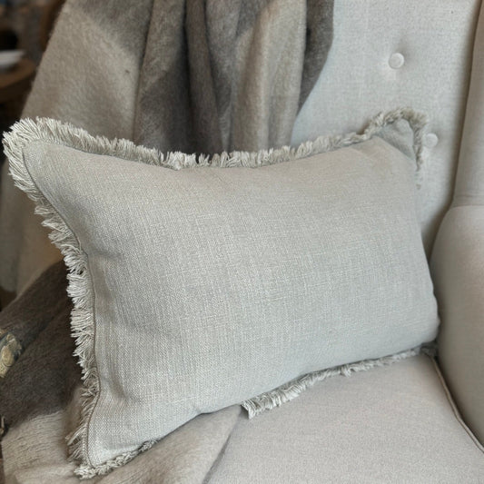 Indulge in the luxurious comfort and elegant style of the Natural Stone Fringed Lumbar Cushion. Made with exquisite heavyweight French linen, this cushion adds sophistication and warmth to any home décor. With its timeless design and subtle colour hue, it is sure to create an inviting and tasteful atmosphere in your space. Styled.
