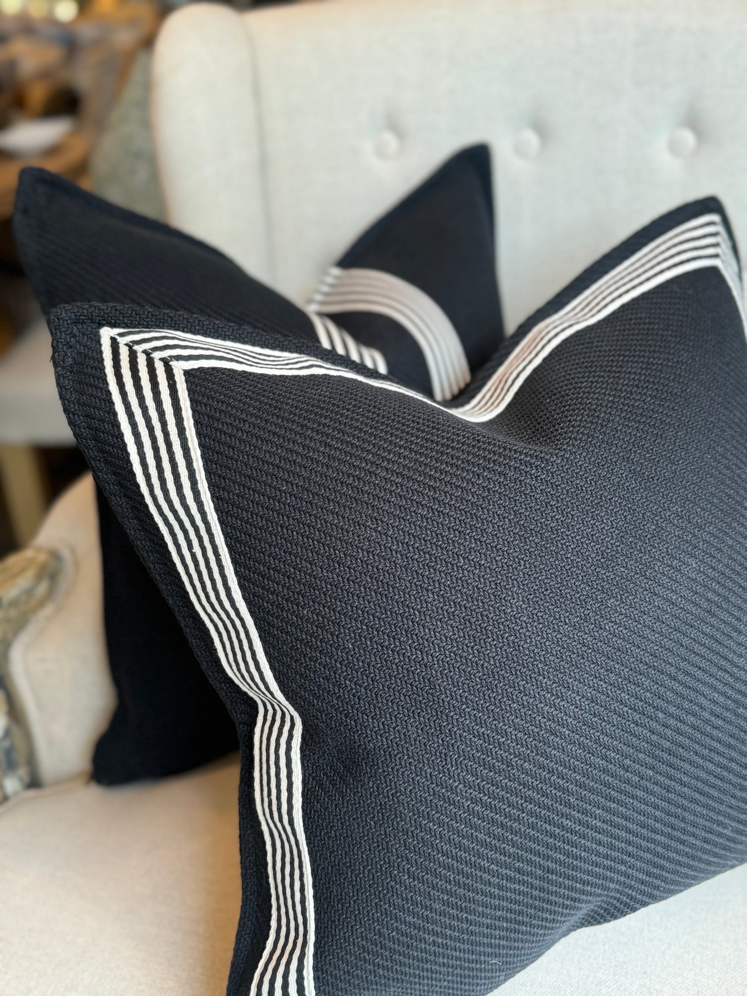 Channeling the sleek elegance of Milano's fashion district, each Black & White Herringbone Textured Cushion features the striking contrast of black and white, evoking the timeless beauty of the marble found in both ancient Italian villas and modern Milanese ateliers.