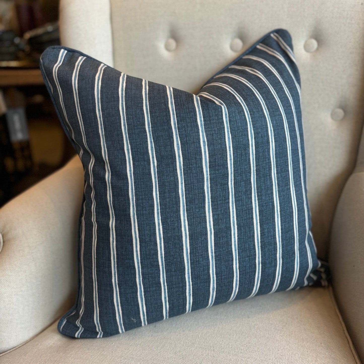 Embrace the luxurious softness of Slender Morris fabric with the Boston Blue and White Rowing Stripe Linen Cushion. Featuring a bold navy and light blue striped design, this cushion is double-sided and self-piped for a polished look. Plus, our feather insert ensures the ultimate comfort. The reverse is lined with oatmeal linen, adding the perfect finishing touch.