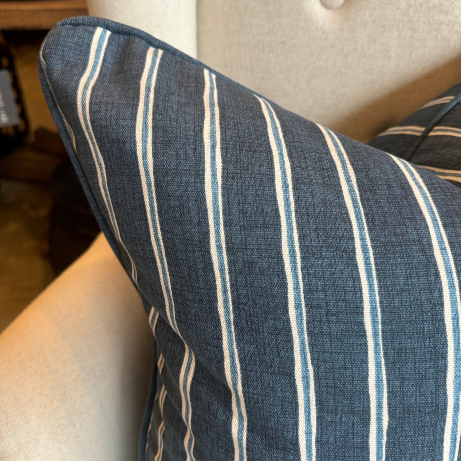 Embrace the luxurious softness of Slender Morris fabric with the Boston Blue and White Rowing Stripe Linen Cushion. Featuring a bold navy and light blue striped design, this cushion is double-sided and self-piped for a polished look. Plus, our feather insert ensures the ultimate comfort. The reverse is lined with oatmeal linen, adding the perfect finishing touch.