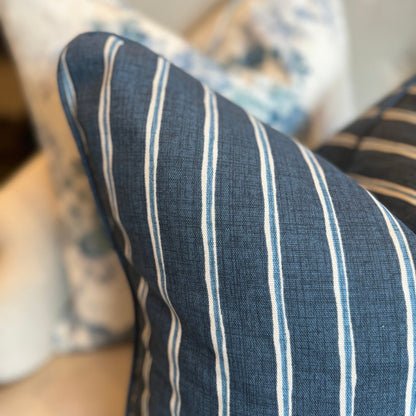 Embrace the luxurious softness of Slender Morris fabric with the Boston Blue and White Rowing Stripe Linen Cushion. Featuring a bold navy and light blue striped design, this cushion is double-sided and self-piped for a polished look. Plus, our feather insert ensures the ultimate comfort. The reverse is lined with oatmeal linen, adding the perfect finishing touch.