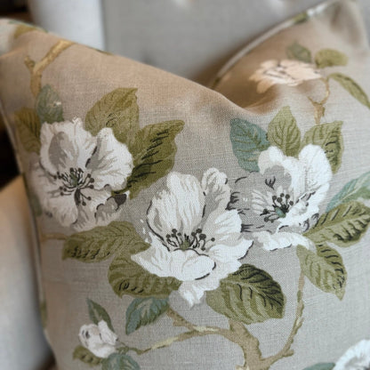 Feel the masterful artistry of Claudié's Taupe Floral Linen Cushion. Handcrafted from Warwick Fabrics' high quality material, this cushion boasts a stunning floral pattern in soft light blue and pale green against a neutral taupe backdrop. A feather insert provides unmatched comfort, and the reverse side is lined with matching taupe linen.