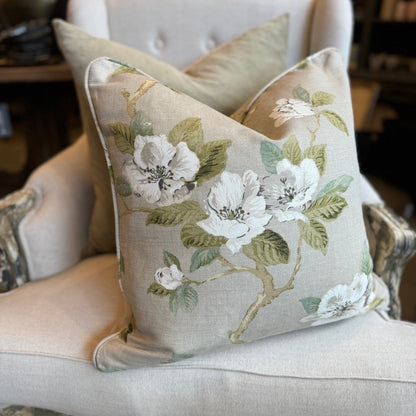 Feel the masterful artistry of Claudié's Taupe Floral Linen Cushion. Handcrafted from Warwick Fabrics' high quality material, this cushion boasts a stunning floral pattern in soft light blue and pale green against a neutral taupe backdrop. A feather insert provides unmatched comfort, and the reverse side is lined with matching taupe linen.