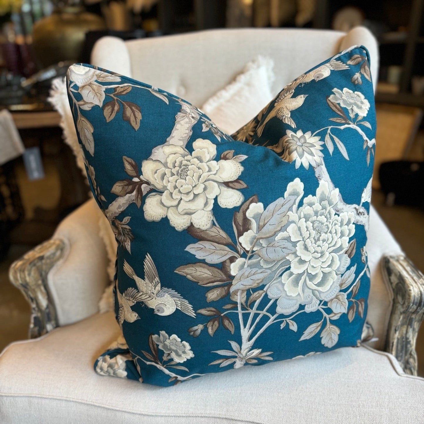 Transform your living space with the breath taking Ophelia Bird &amp; Floral Spray Cushion, adorned with beautiful flying birds and blooming branches on a luxurious teal backdrop. Crafted from soft cotton fabric, this cushion comes with a feather insert for ultimate comfort.