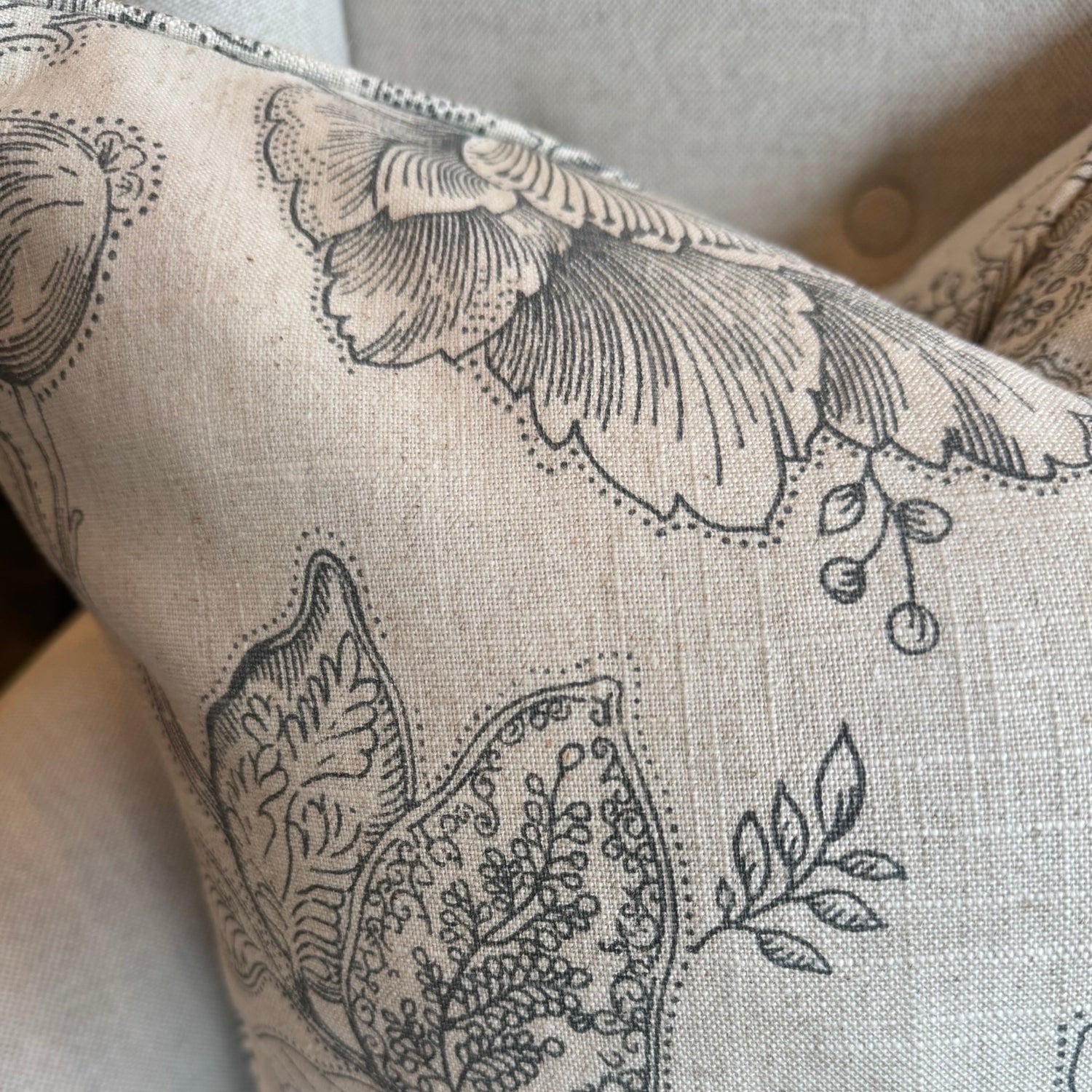 The Brielle Oatmeal and Charcoal Floral Linen Cushion boats a delightful charcoal floral pattern on a serene oatmeal backdrop. Its feather filling guarantees ultimate comfort, and the back is lined with matching oatmeal linen for a harmonious finish.