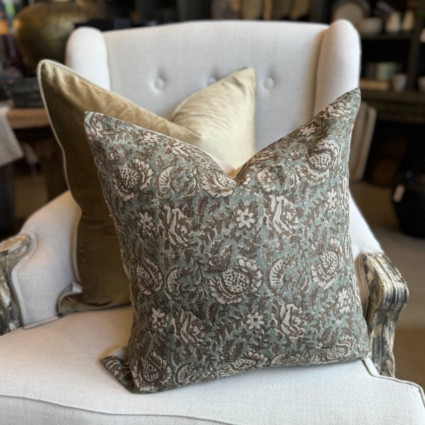 Create an atmosphere of elegance and sophistication in your home with the Claudette Floral Linen Cushion. Its stunning floral print, in muted brown, white, and green tones, is sure to add a touch of nature to any room. And with a soft linen material and included feather insert, it's the perfect addition to your cozy and stylish decor. Don't miss out on this beautiful piece!