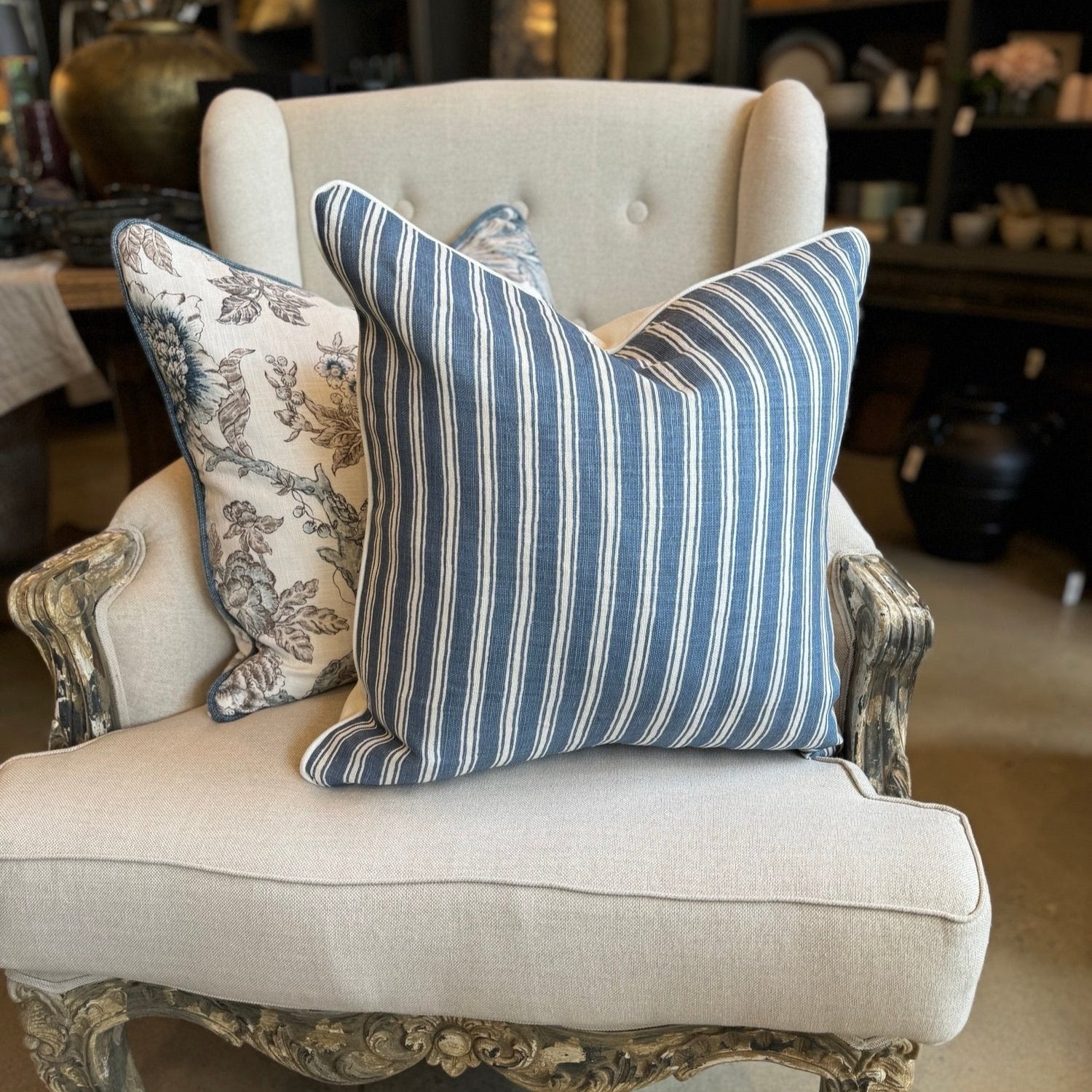 Embrace elegance with the timeless heavyweight design of the Capri Blue &amp; Ivory Stripe Cushion. Its sophisticated pattern and luxurious feather insert will inspire a sense of refinement and comfort in any space. The combination of off-white and blue tones adds a touch of sophistication to your decor.