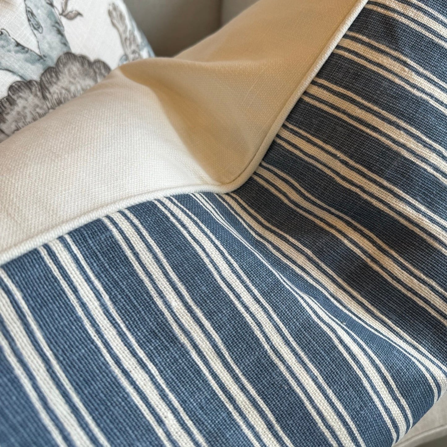 Embrace elegance with the timeless heavyweight design of the Capri Blue &amp; Ivory Stripe Cushion. Its sophisticated pattern and luxurious feather insert will inspire a sense of refinement and comfort in any space. The combination of off-white and blue tones adds a touch of sophistication to your decor.