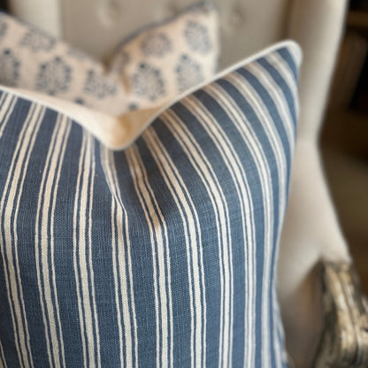 Embrace elegance with the timeless heavyweight design of the Capri Blue &amp; Ivory Stripe Cushion. Its sophisticated pattern and luxurious feather insert will inspire a sense of refinement and comfort in any space. The combination of off-white and blue tones adds a touch of sophistication to your decor.