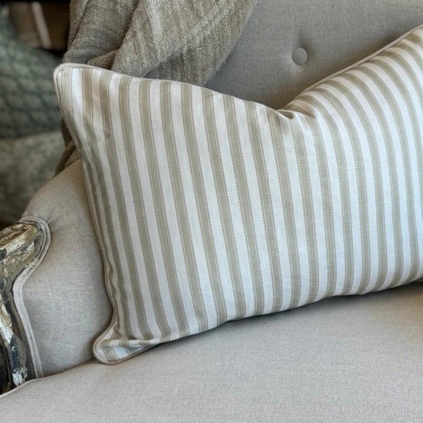 Indulge in the luxurious feel of our Striped Pale Olive &amp; Ivory Lumbar Cushion crafted from a sumptuous heavyweight fabric. The pale olive stripe against ivory background exudes timeless elegance and grace, making it the perfect addition to any sophisticated home decor. Comes with a luxurious feather insert for added comfort.