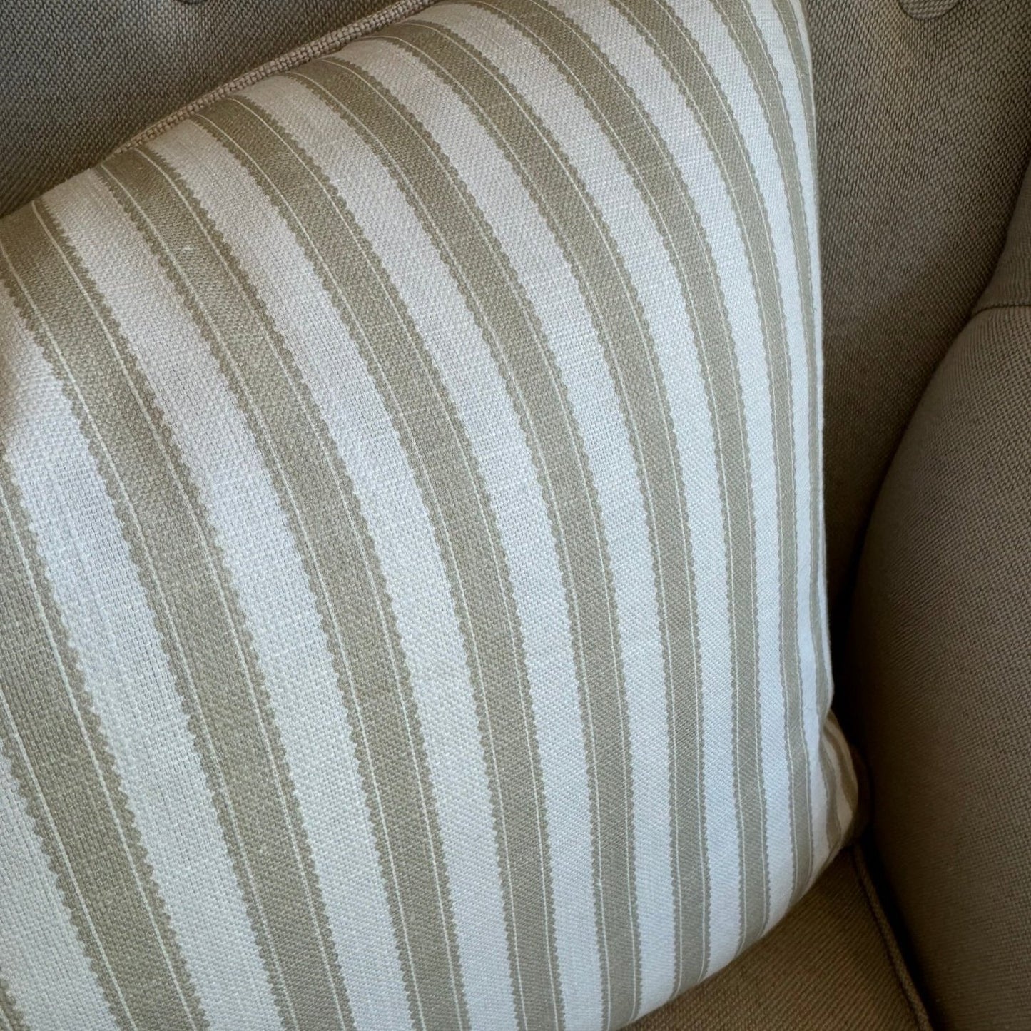 Indulge in the luxurious feel of our Striped Pale Olive &amp; Ivory Lumbar Cushion crafted from a sumptuous heavyweight fabric. The pale olive stripe against ivory background exudes timeless elegance and grace, making it the perfect addition to any sophisticated home decor. Comes with a luxurious feather insert for added comfort.