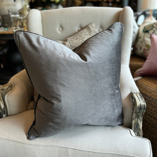 Experience the luxurious softness of our Dark Grey Velvet Cushion. This stylish and elegant cushion features a concealed zipper for effortless use and is filled with feather inserts for ultimate comfort. It is also machine washable on a delicate cycle, making it perfect for adding style and comfort to any bed or sofa.