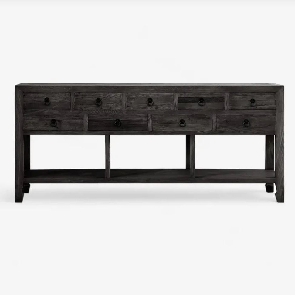 Long dark wooden console table with multiple drawers on a white background