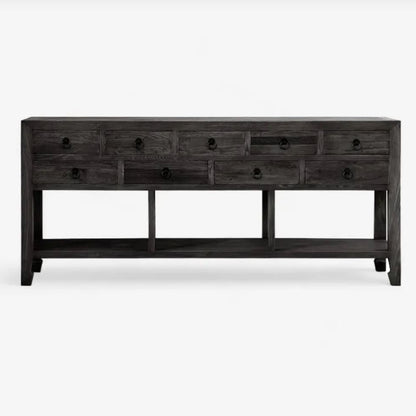 Long dark wooden console table with multiple drawers on a white background