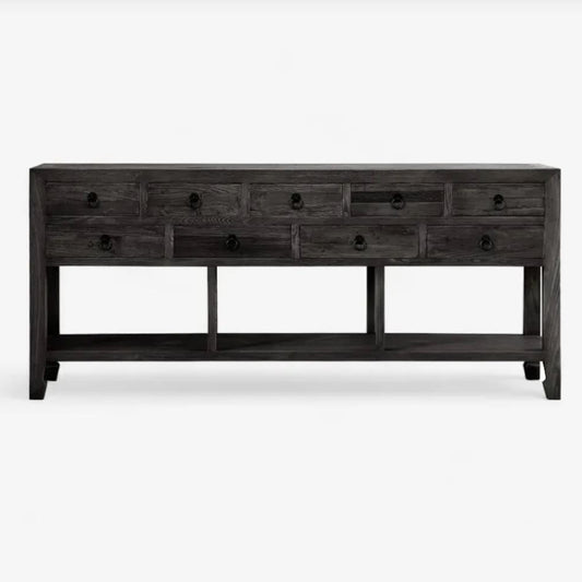 Long dark wooden console table with multiple drawers on a white background