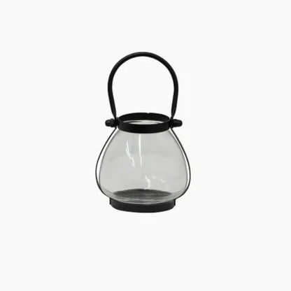 Clear glass lantern with black handle on a white background
