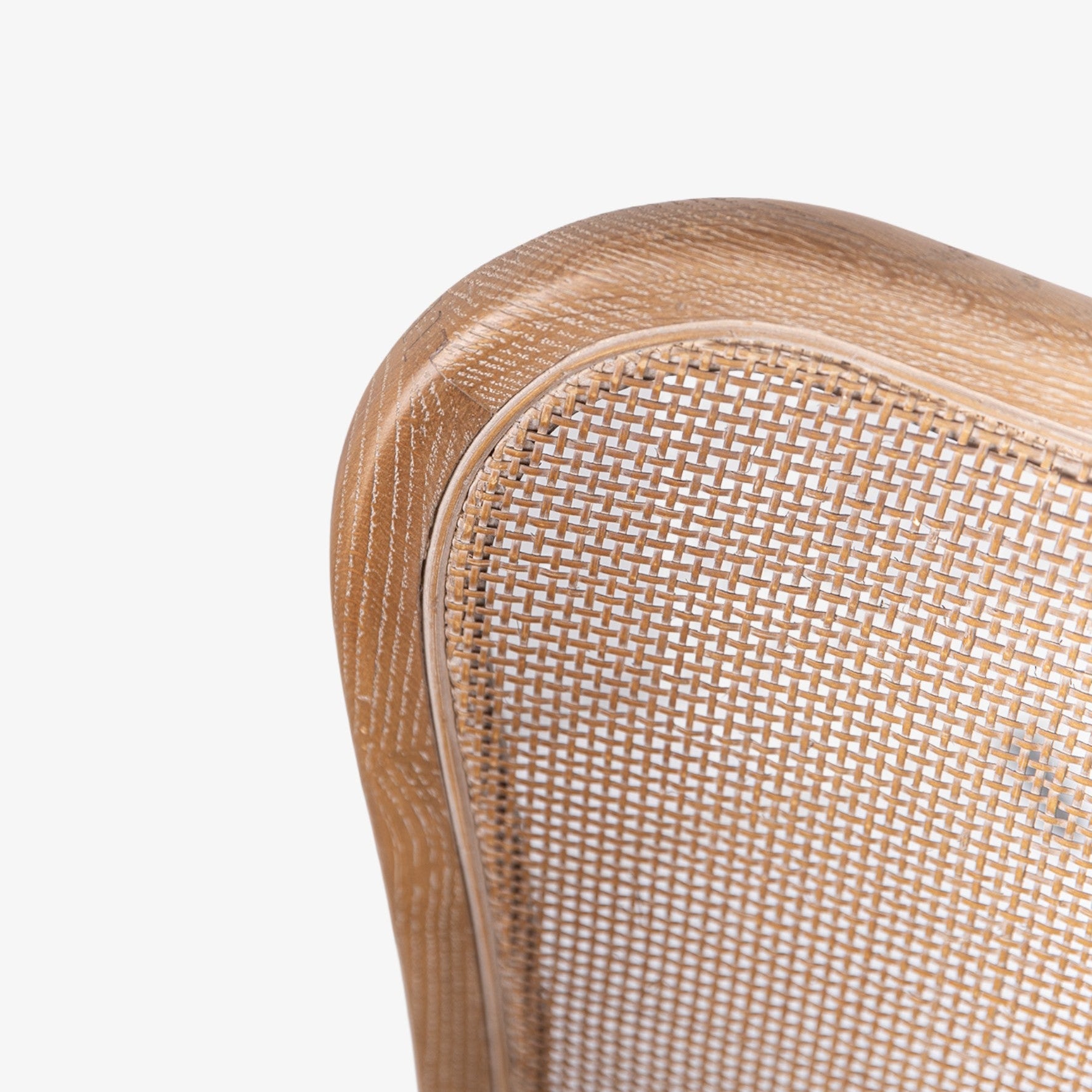 Close-up of a wooden chair with woven backrest on a white background