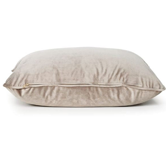 A square beige velvet throw pillow with a zippered edge, shown on a clean white background.