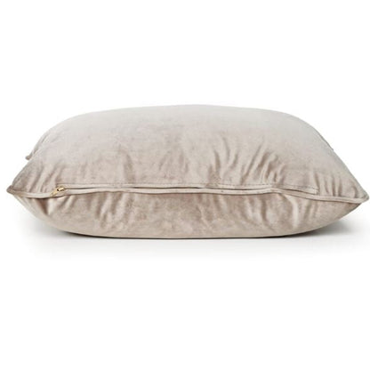 A square beige velvet throw pillow with a zippered edge, shown on a clean white background.