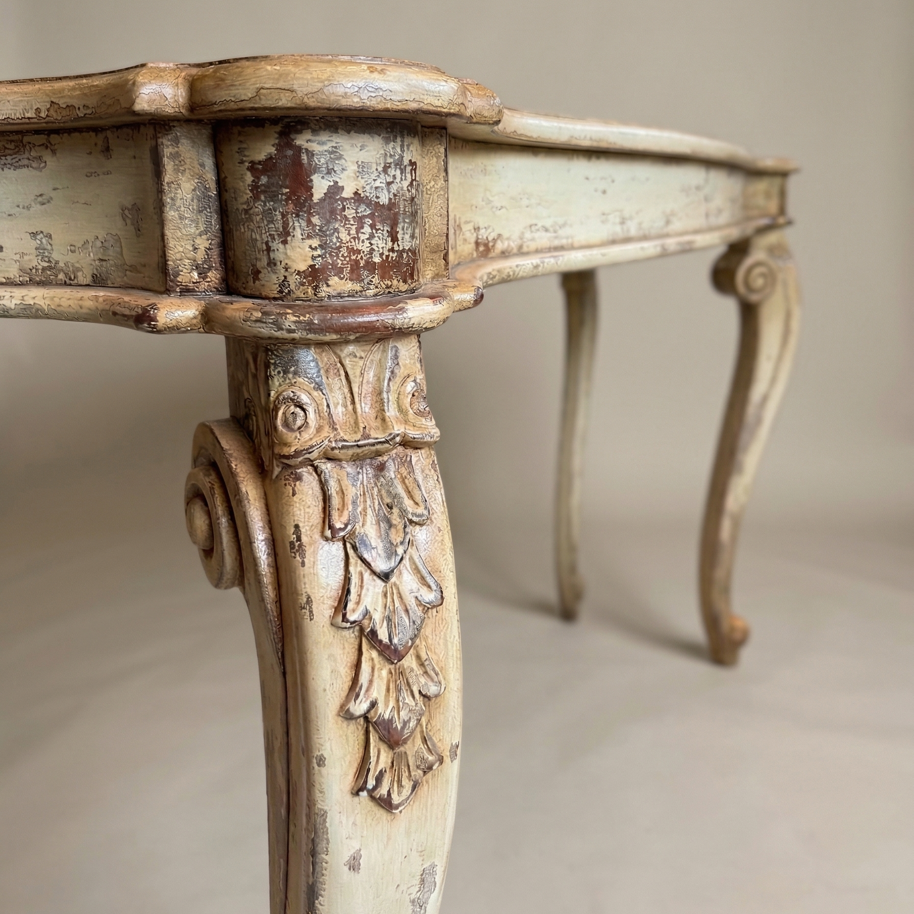 Vintage-style table with ornate legs on a neutral background