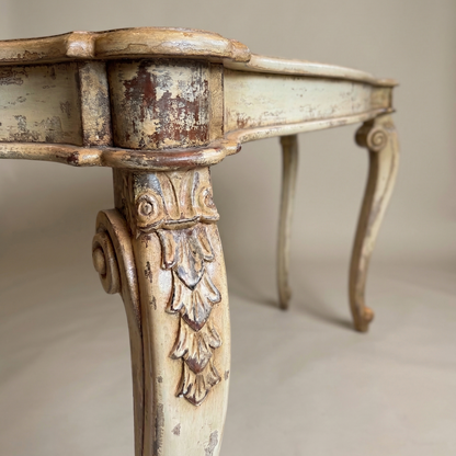 Vintage-style table with ornate legs on a neutral background
