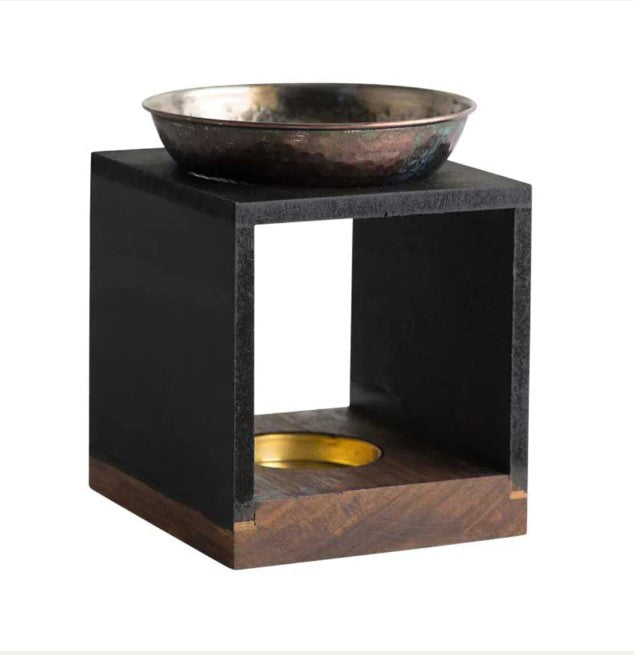 Experience the aroma of your favorite essential oil with the Cahya Oil Burner. Crafted with a wooden frame and detailed with silver metal, this product is sure to delight your senses.