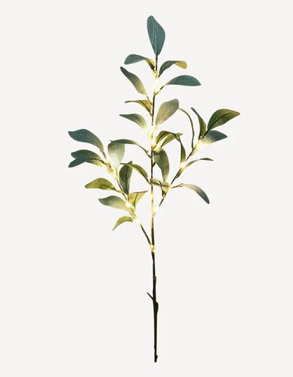 This Faux Olive Light Up Branch is a luxurious addition to any home. 15 LED lights adorn the lovely faux greenery, creating an elegant and timeless look that adds a unique touch to seasonal decor. Perfect for vases or pots, it adds a special ambiance to any space.