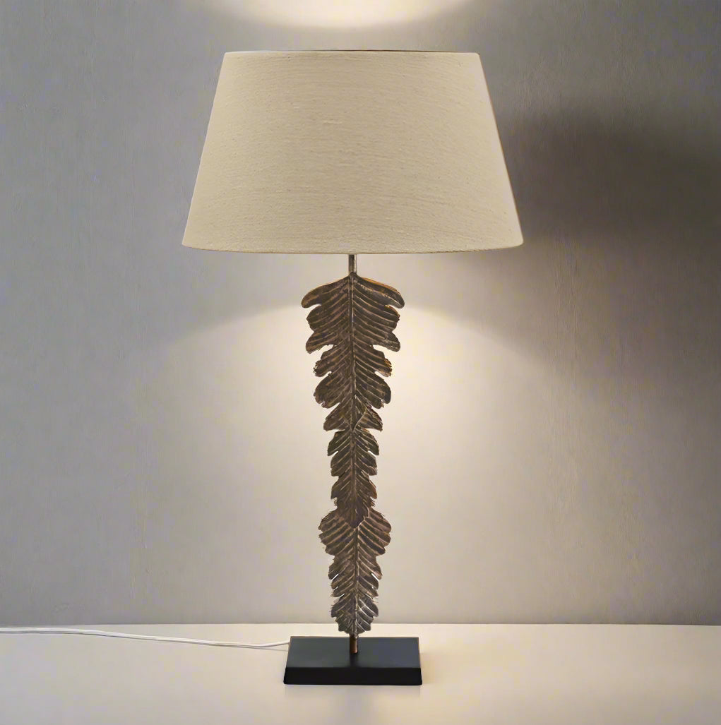 Experience the striking beauty of the Palma Lamp in any room of your home. Crafted from durable iron with a stunning palm bronze finish, this lamp is a true statement piece. The gorgeous Flax Basket Weave Drum shade perfectly complements the design, creating a captivating atmosphere in any space. Lamp requires a B22 bayonet bulb.