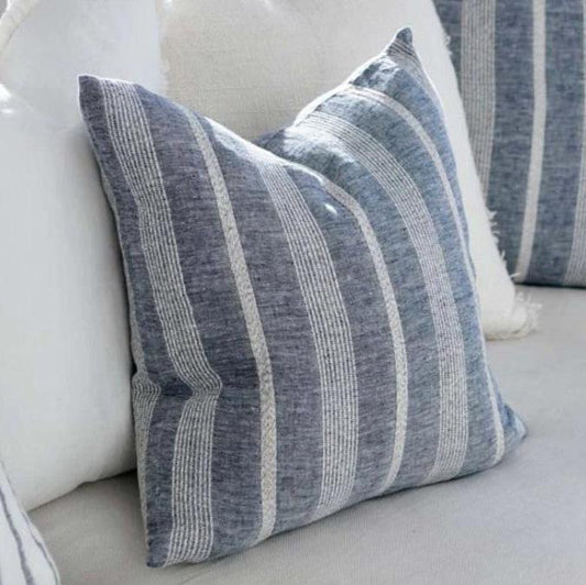 The Paros Chambray Striped Linen Cushion is made from a striking yarn-dyed chambray linen fabric featuring an elegant white stripe pattern. It comes with a superior plush feather insert, crafted to provide maximum comfort. Additionally, this product has attained OEKO-TEX® and GOTS certifications.